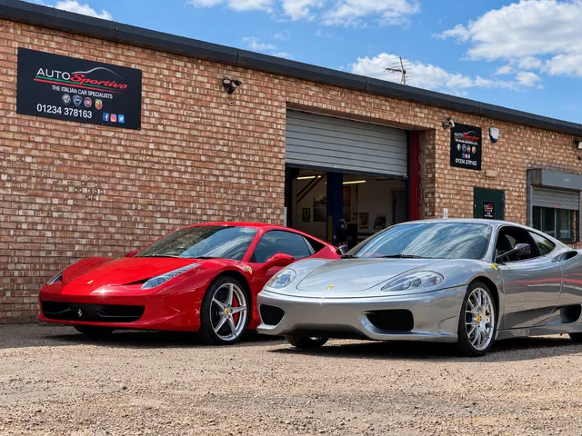 A red Ferrari 458 and a silver Ferrari 360 parked outside the Auto Sportivo workshop