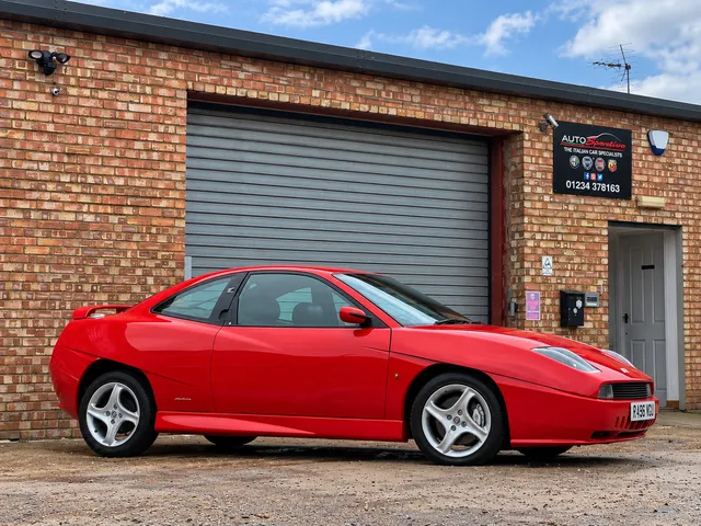 A red Fiat Coupe outside the Auto Sportivo unit